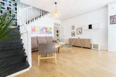 a living room with a couch and a table and chairs at Casa Premia in Premiá de Mar