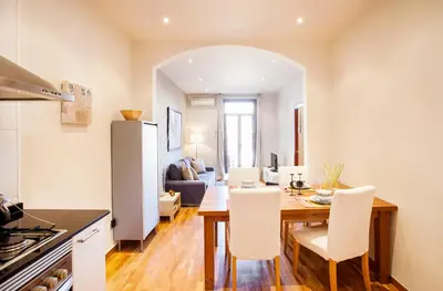 a kitchen and dining room with a table and chairs at Apartments Barcelona & Home Deco Viladomat in Barcelona