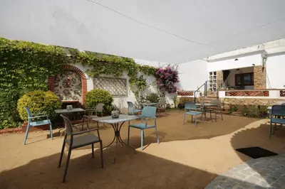 a group of chairs and tables on a patio at B&B Sant Pol - Adults Only in San Pol de Mar