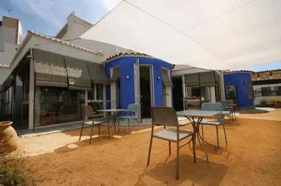 a table and chairs in front of a house at B&B Sant Pol - Adults Only in San Pol de Mar