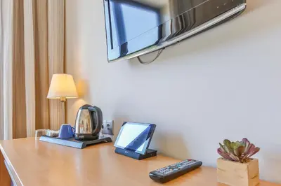 a desk with a television and a computer on it at Hotel Desitges in Sant Pere de Ribes