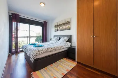 a bedroom with a bed and a large window at Jie Apartment in Sant Adria de Besos