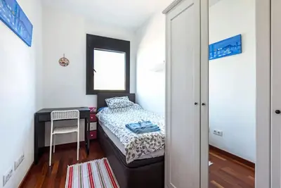 a small bedroom with a bed and a desk at Jie Apartment in Sant Adria de Besos
