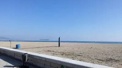 a sandy beach with a volley ball hoop at Jie Apartment in Sant Adria de Besos