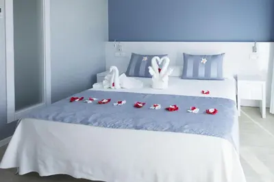 a bed with a bunch of stuffed animals on it at Masd Mediterraneo Hotel Apartamentos Spa in Castelldefels