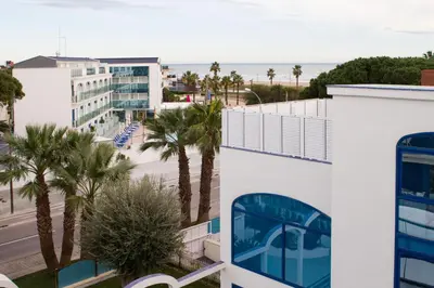 a view of the beach from the balcony of a building at Masd Mediterraneo Hotel Apartamentos Spa in Castelldefels