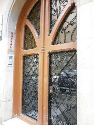 a door with a wrought iron gate in a building at Hostal Absolut Stay in Barcelona