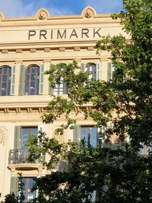 a building with a pharmacy sign on the side of it at Hostal Absolut Stay in Barcelona
