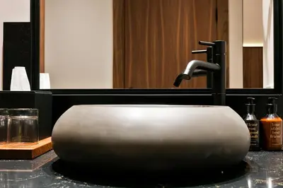 a sink with a faucet on a bathroom counter at Yurbban Passage Hotel & Spa in Barcelona