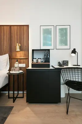 a room with a desk with a bed and a chair at Yurbban Passage Hotel & Spa in Barcelona