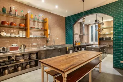 a large kitchen with a wooden table in it at Casa Gracia in Barcelona