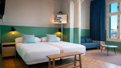 a hotel room with a bed and a table at Casa Gracia in Barcelona