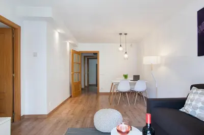a living room with a couch and a table at Tendency Apartments Fira in Hospitalet de Llobregat