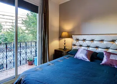 a bedroom with a bed and a large window at Valencia Suite ArchsenseApartments in Barcelona