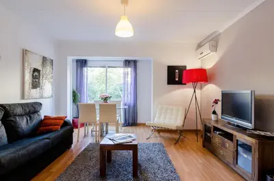 a living room with a couch and a tv and a table at Valencia Suite ArchsenseApartments in Barcelona