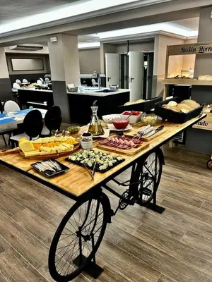a table with food on it in a cafeteria at Summer Hotel in Calella