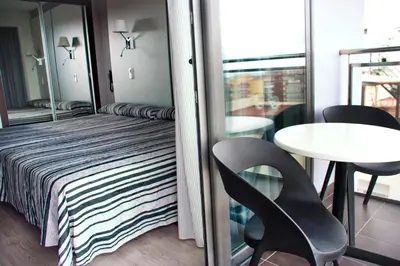 a room with a bed and a chair and a table at Summer Hotel in Calella