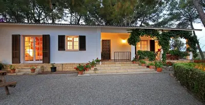 a house with stairs and a porch with flowers at Casa Rural Els Pins in Sant Marçal