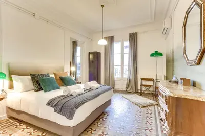 a bedroom with a large bed and a mirror at Sweett - Aragon in Barcelona