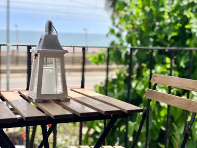 a lantern sitting on top of a wooden bench at Vilamarlux II in Vilassar de Mar