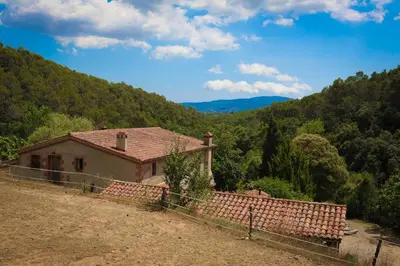 a small house in the middle of a mountain at Can Parròquia in Sant Esteve de Palautordera