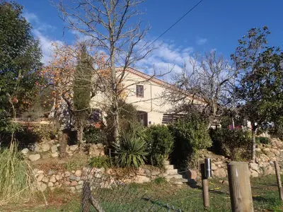 a white house with a fence in front of it at Can Parròquia in Sant Esteve de Palautordera