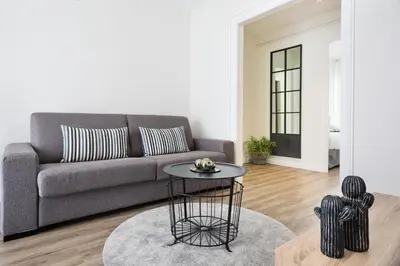 a living room with a couch and a table at Sitges Group Calm Beach in Sitges