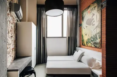 a hotel room with a bed and a window at Barcelona Apartment Republica in Barcelona