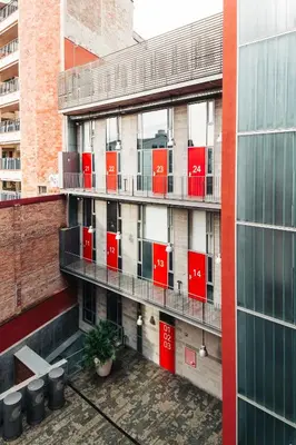 a building with red containers on the side of it at Barcelona Apartment Republica in Barcelona