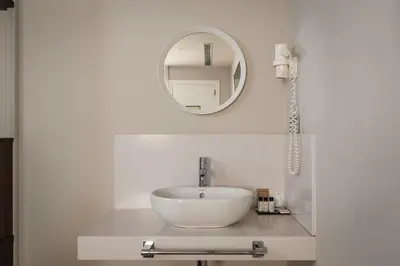 a bathroom with a white sink and a mirror at Arya Stadium Hotel in Barcelona