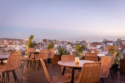 a patio with tables and chairs and a view of the city at Arya Stadium Hotel in Barcelona