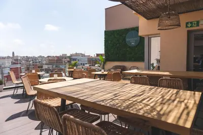 a table and chairs on a patio with a view at Arya Stadium Hotel in Barcelona