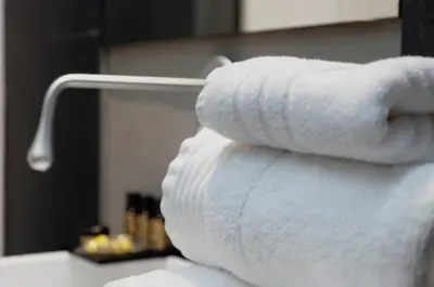 a stack of towels on a towel rack in a bathroom at Cosmopolitan Boutique Rambla in Barcelona
