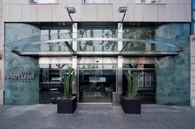 a building with two potted plants in front of it at Hotel Actual in Barcelona
