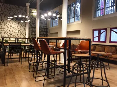 a group of chairs and a table in a room at Safestay Barcelona Gothic in Barcelona