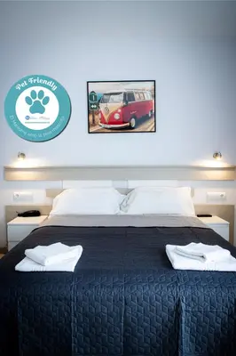 a bed with two white towels on top of it at Apartamentos Comfort Calella in Calella