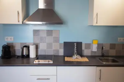 a kitchen with a sink and a counter top at Apartamentos Comfort Calella in Calella