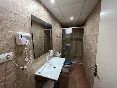 a bathroom with a sink and a shower and a toilet at Apartamentos Comfort Calella in Calella
