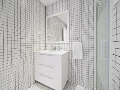 a white bathroom with a sink and a mirror at Urban Chill Apartments by Olala Homes in Hospitalet de Llobregat