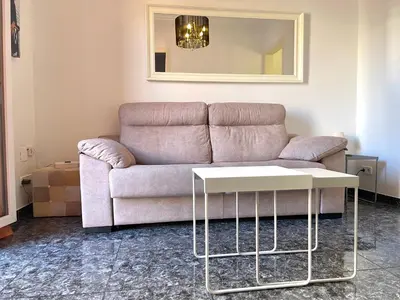 a living room with a couch and a table at Elegantniy Poble Sec in Barcelona