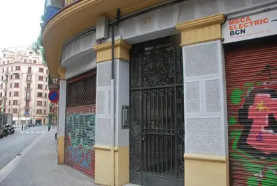 a building with a black door with graffiti on it at Elegantniy Poble Sec in Barcelona