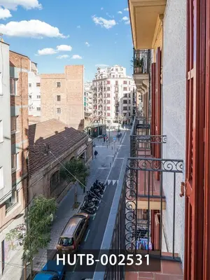 a view of a city street from a balcony at Elegantniy Poble Sec in Barcelona