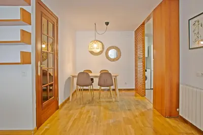 a dining room with a table and two chairs at Alcam El Coll in Barcelona