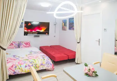 a bedroom with a bed and a flat screen tv at Camp Nou, Europa Fira - modern two-bedroom apartment with heating in Hospitalet de Llobregat