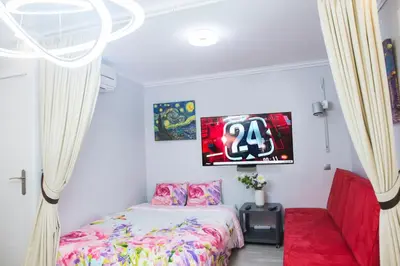 a bedroom with a bed and a tv on the wall at Camp Nou, Europa Fira - modern two-bedroom apartment with heating in Hospitalet de Llobregat