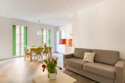 a living room with a couch and a table at Cosmo Apartments Marina – Auditori in Barcelona
