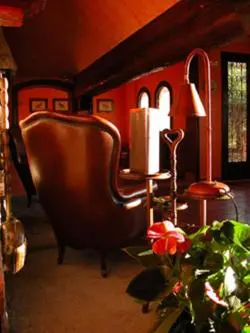 a living room with a chair and a table at Masia Vista Hermosa in Vallromanas