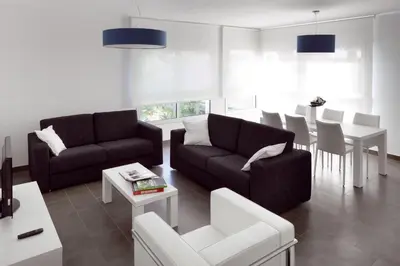 a living room with two couches and a table at 08028 Apartments in Barcelona