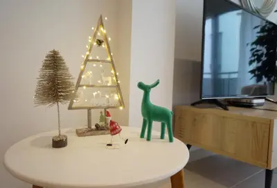 a table with a christmas tree and a christmas toy at Matilda Home on the Beach in Sitges