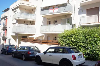 two cars parked in front of a building at Matilda Home on the Beach in Sitges